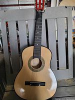 Full front view of natural finish Pyle acoustic guitar showing body, neck, and headstock.