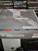 Box of ASUS ROG Strix B550-A Gaming motherboard showing branding and specs.