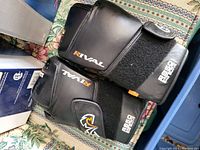 Top view of Rival glove showing logo, ABSO Gel branding, velcro wrist strap with elastic section on patterned fabric.