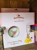 Photo of the Royal Doulton Bunnykins 3-piece melamine set (plate, bowl, cup) in original packaging.