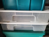 Photo of two white translucent plastic storage totes stacked with white lids, showing front handle design.