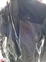 Front view of the dark gray textured Mountain Warehouse jacket, zippered front and pockets visible