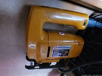 Yellow Black & Decker variable speed jigsaw with visible branding and specifications, showing overall used but good condition.