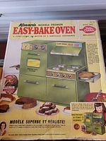 Photo of vintage Kenner Easy Bake Oven Model Premier box showcasing product features and pictures of desserts.