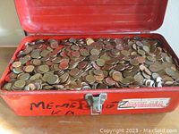 Interior view of toolbox open and filled with loose Canadian pennies.