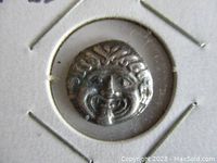 Close-up of the obverse side of the coin showing Medusa's face with detailed hair and facial features.