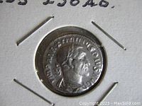 Obverse side of the ancient silver coin showing Emperor Maximinus Thrax's portrait and inscriptions.