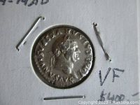 Obverse side of the silver denarius showing the profile bust of Emperor Vespasian with inscription.