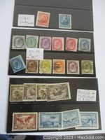 Photo showing an assortment of antique Canadian stamps mounted on a black file card with small white handwritten notes showing catalogue numbers and approximate prices.