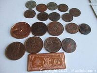 Overview of all copper coins and novelty bar arranged on white background