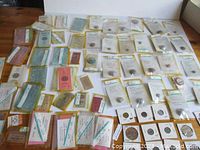 Full spread of the collection laid out on a flat surface showing plastic sleeves with tokens/buttons and stacks of tickets.