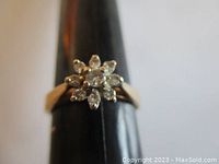 Front view of diamond cluster ring on mandrel