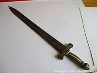 Full view of sword laid flat on white background