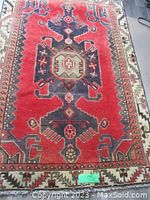 Full top view of red tribal Mazleghan rug showing central medallion and border pattern
