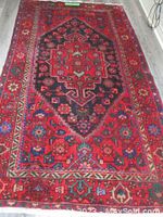 Full view of rug laid flat on floor showing overall design and condition