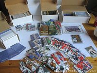 Overview of multiple open boxes, loose cards, sealed packs, and display cards spread on table