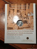 Front of the cardboard holder with the coin visible inside, featuring a historic photo and commemorative text.