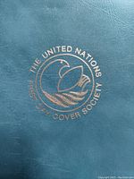 Close-up photo of the blue cover embossed with the United Nations First Day Cover Society logo.