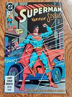 Close-up photo of Superman comic book issue 48 showing cover 'Superman Versus Sinbad' with dynamic artwork