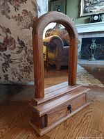 Vintage Mexican folk art arched mirror with wooden frame and single drawer base.