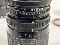 Close-up photo of Albinar zoom lens showing aperture and focal length markings
