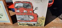 Close-up, angled photo of the canvas print showing the front left corner of the red and white 1950 Ford pickup truck illustration.