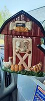 Front and side view of ceramic barn cookie jar with mouse, chicken, and rooster figures.