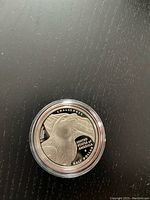 Obverse side of the 2008 Liberty half dollar coin showing eagle head with Challenger inscription.