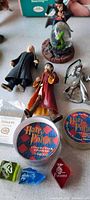 Harry Potter figures displayed with game stones, collectible containers and themed dice.