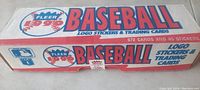 Top and side views of the sealed 1990 Fleer baseball logo stickers and trading cards box showing branding and quantity details.