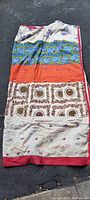 Full view of the antique quilted sleeping bag spread out showing varied fabric panels and colorful patterns.