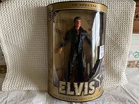 Full view of the Elvis doll displayed in original packaging, showing front view of doll and packaging details.