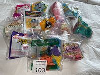Overview of all McDonald's Happy Meal toys laid out on a surface showing different packages and toys