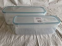 Two new clear KOMAX rectangular containers stacked with lids, showing size difference and new condition.
