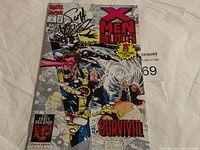 Front cover of X-Men Unlimited Survival #1 comic book showing the signed cover and comic art with characters and title.
