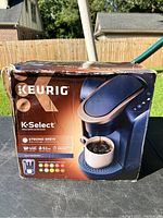 Photo of Keurig K-Select coffee maker box showing front and top with product image and specifications.