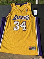 Front view of yellow Lakers basketball jersey with number 34 and NBA logo.
