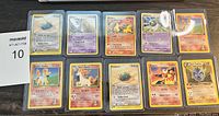 Photo showing all 10 Pokemon cards laid out in two rows, including Blastoise, Charizard, and others.