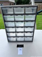 Front view of gray plastic organizer with 21 clear drawers arranged in rows for storing small items.