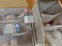 Dolls securely packed in original boxes with bubble wrap, showing doll faces and accessories like ice-cream cone and balloons.