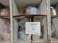 Three Ashton Drake Baby Talk dolls shown individually boxed and wrapped in plastic, viewed from top.