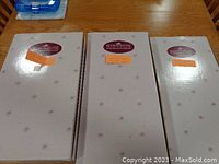 Three closed boxes labeled with collection and doll names on top, showing unopened condition.
