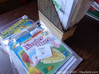 Photo of several educational activity books and workbooks mostly focused on numbers and early math for children, in plastic sleeves.