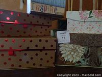 Five decorative storage boxes stacked with visible floral and polka dot patterns, shown from an angle.