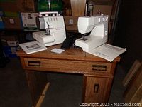 Janome sewing machine and Singer serger placed on the wooden cabinet showing overall lot contents