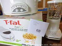 Photo showing T-fal ActiFry Original box, Rival Crock-Pot, KitchenAid blender together.