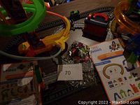 View of the Crank Tower spiral launcher, several mini trains in packaging, and additional track pieces spread out on a table.