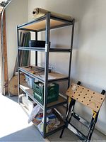 Full view of the assembled shelving unit with various items stored on shelves and workbench nearby.