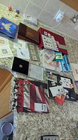 Overview of the assorted stamp collection spread out on a counter including albums, booklets, and various items related to stamps.