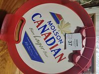 Plastic serving tray with red edges and Molson Canadian logo in center, showing front branding.